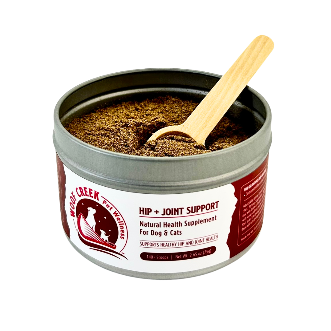 Tin of natural health supplement for dogs and cats with a wooden scoop on a white background