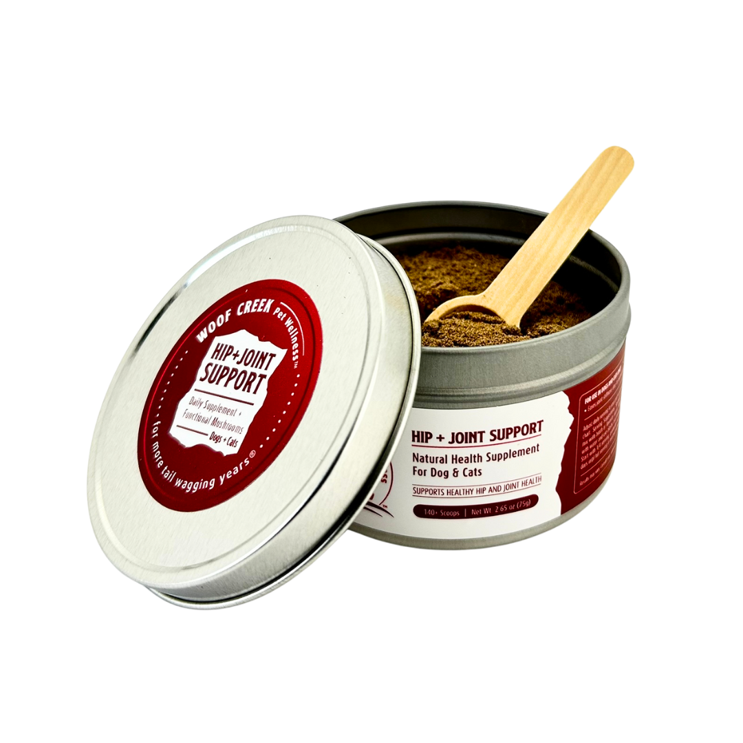 Open tin of hip-joint support supplement with a wooden scoop on a white background