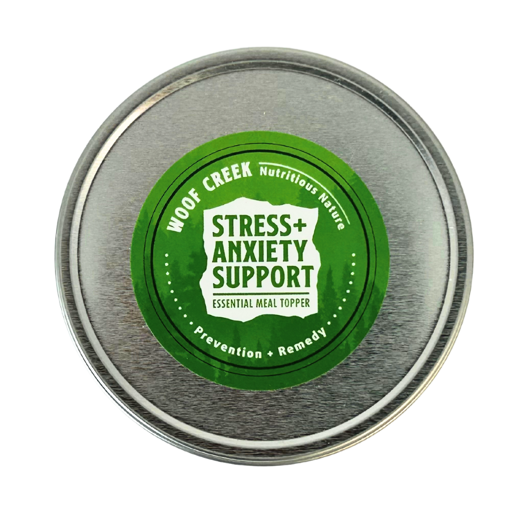 Metal container lid with green label for Woof Creek Stress + Anxiety Support product on a white background