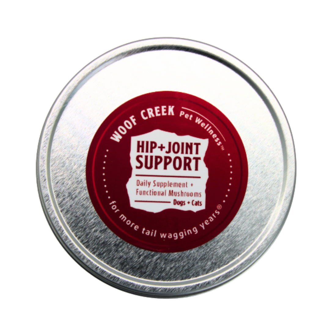 Metal tin labeled 'Woof Creek Pet Wellness Hip + Joint Support' on a white background