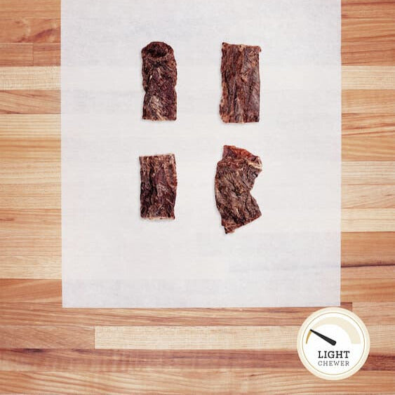 Scrap pieces of beef weasand on parchment paper.