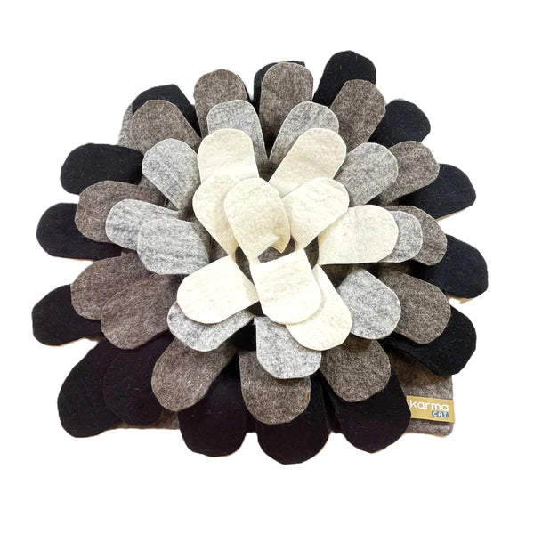 Wool, floral-patterned cat play mat with black, gray, and white petals on a white background
