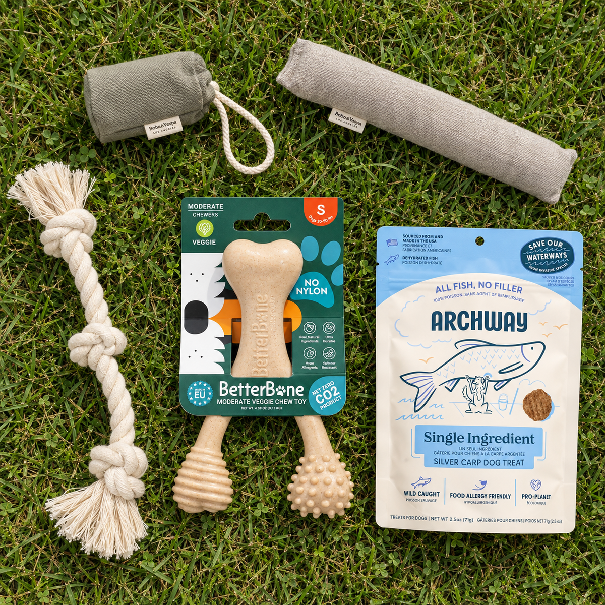 5 dog toys and treats for medium sized dogs laying on the grass