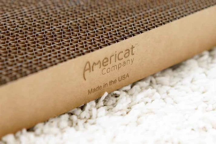 Side view of a cat scratcher that says Americat Company - Made in the USA.