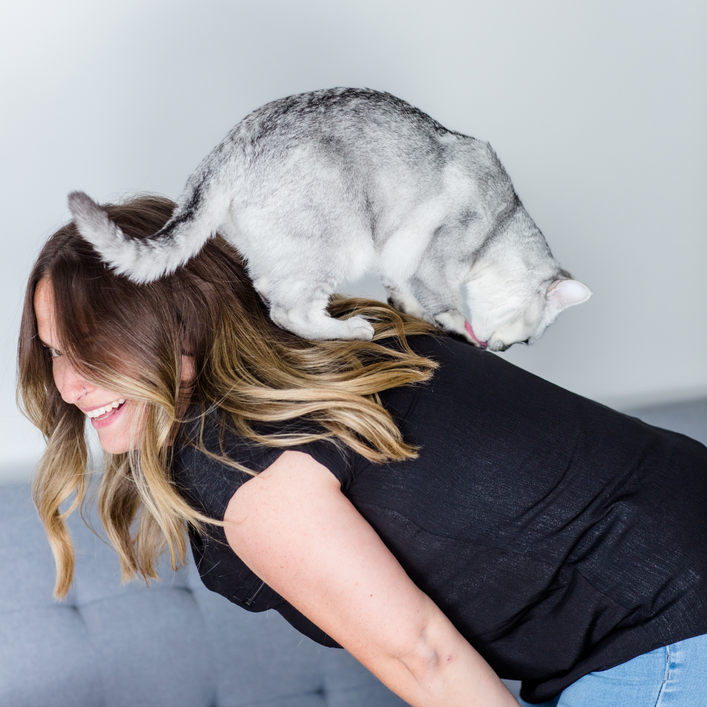 Laura's cat Charlotte walking on her back