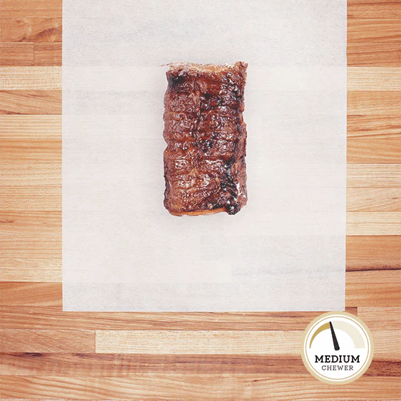 Small piece of beef trachea laying on parchment paper.