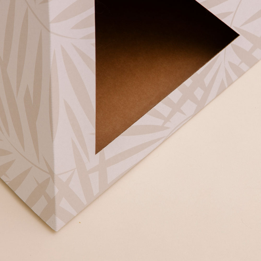 Close-up of geometric pattern printed cardboard cat bed.