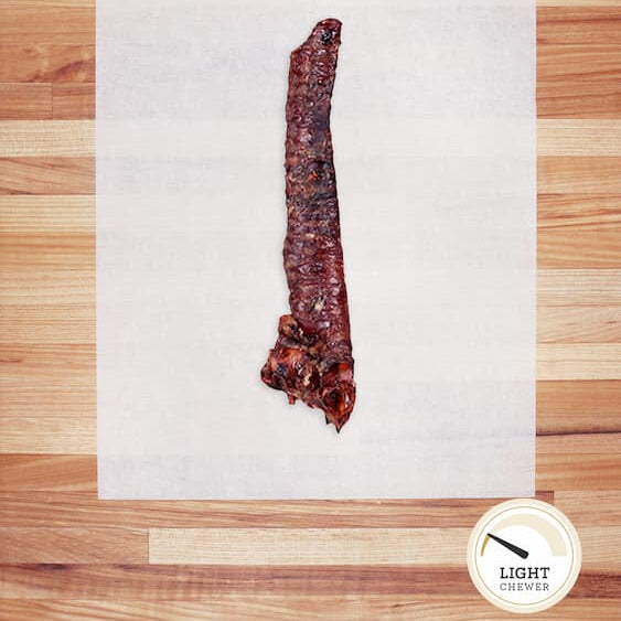 Dehydrated dog trachea on white parchment paper.